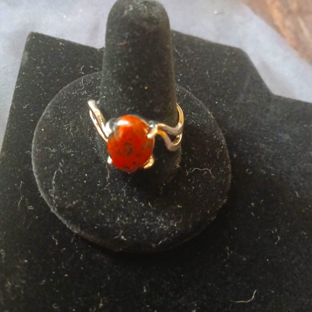 Orange stone ring with black specks